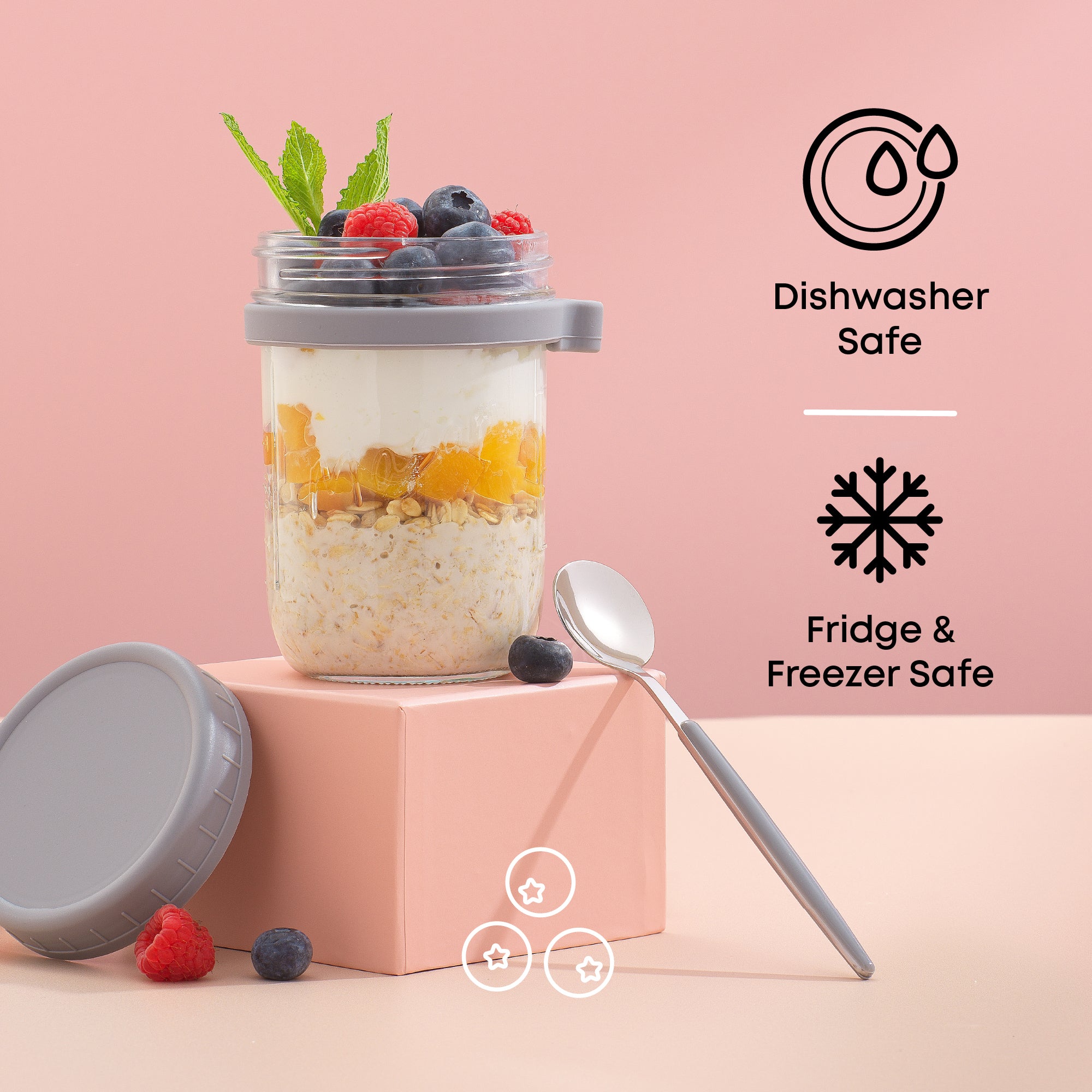 Grey overnight oats container filled with fruit and granola on a pink backdrop. 