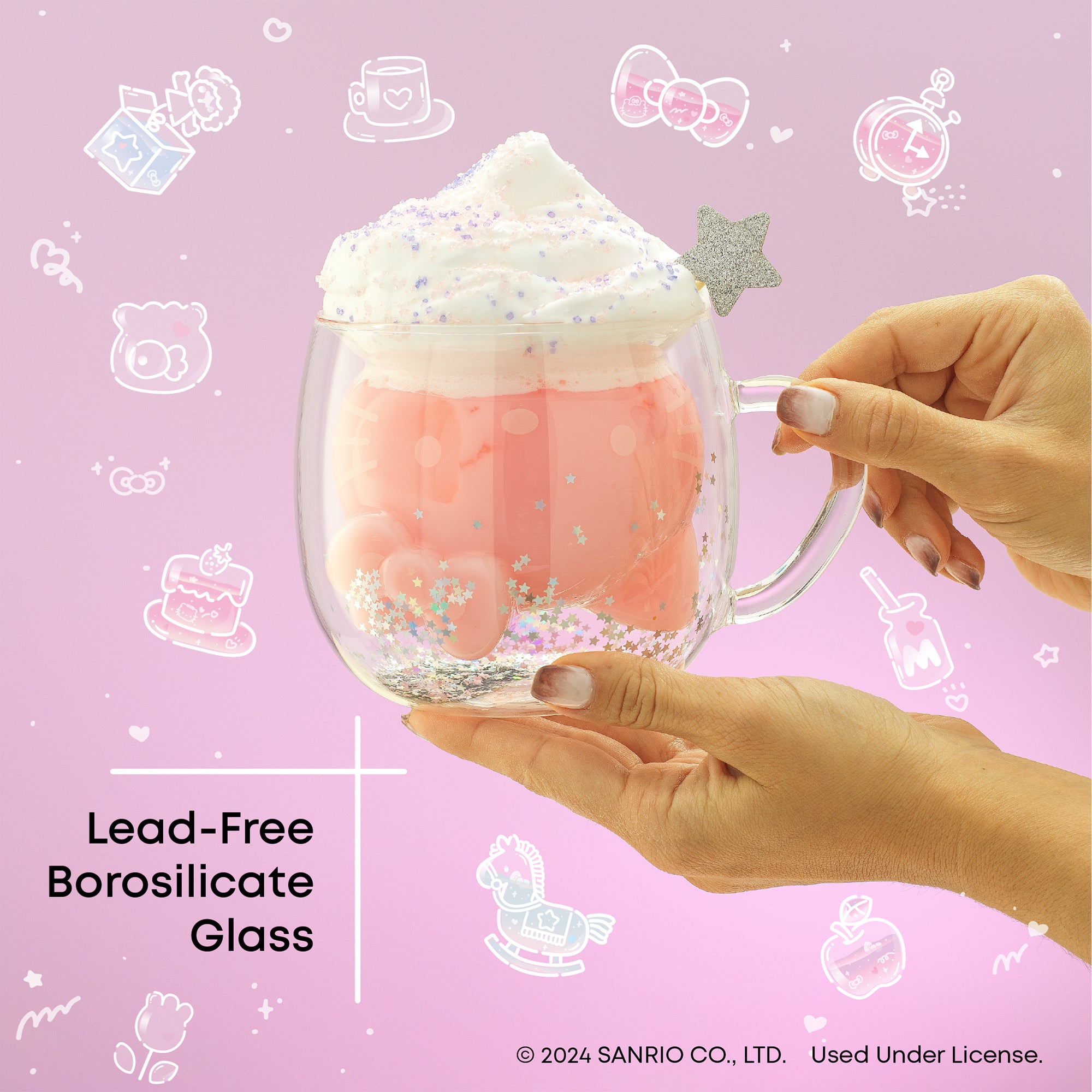 A person holding a pink glass mug with a Hello Kitty design. The text on the image says “Lead-Free Borosilicate Glass."