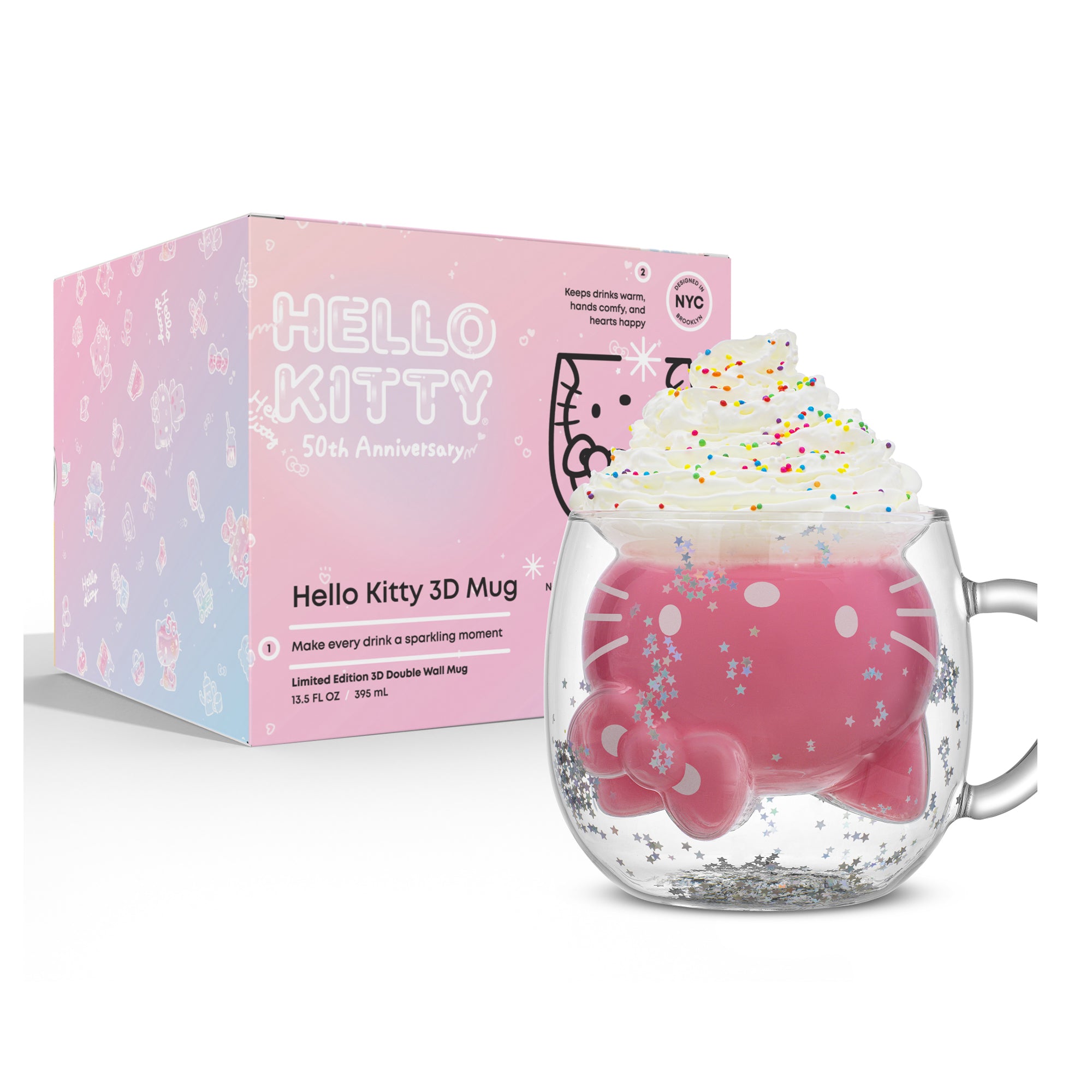 A 3D Hello Kitty Mug with glitter filled with a pink drink and whipped cream. A pink box behind the mug reads, "Hello Kitty 50th Anniversary" and "Limited Edition 3D Double Wall Mug."