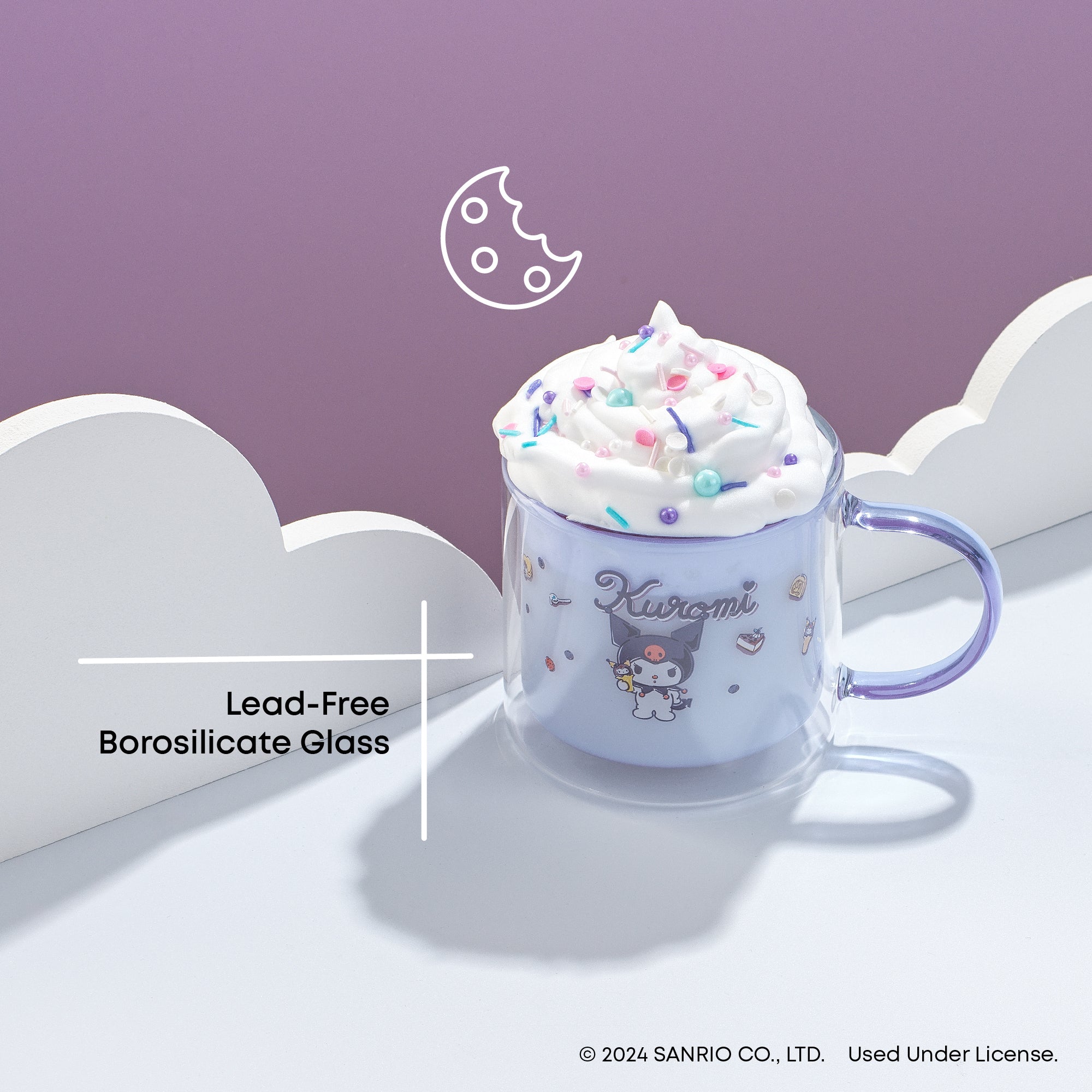 A clear glass mug with whipped cream and a graphic of a chocolate chip cookie on top. The mug has black text that says "Kuromi". The text on the image reads "Lead-Free Borosilicate Glass." 