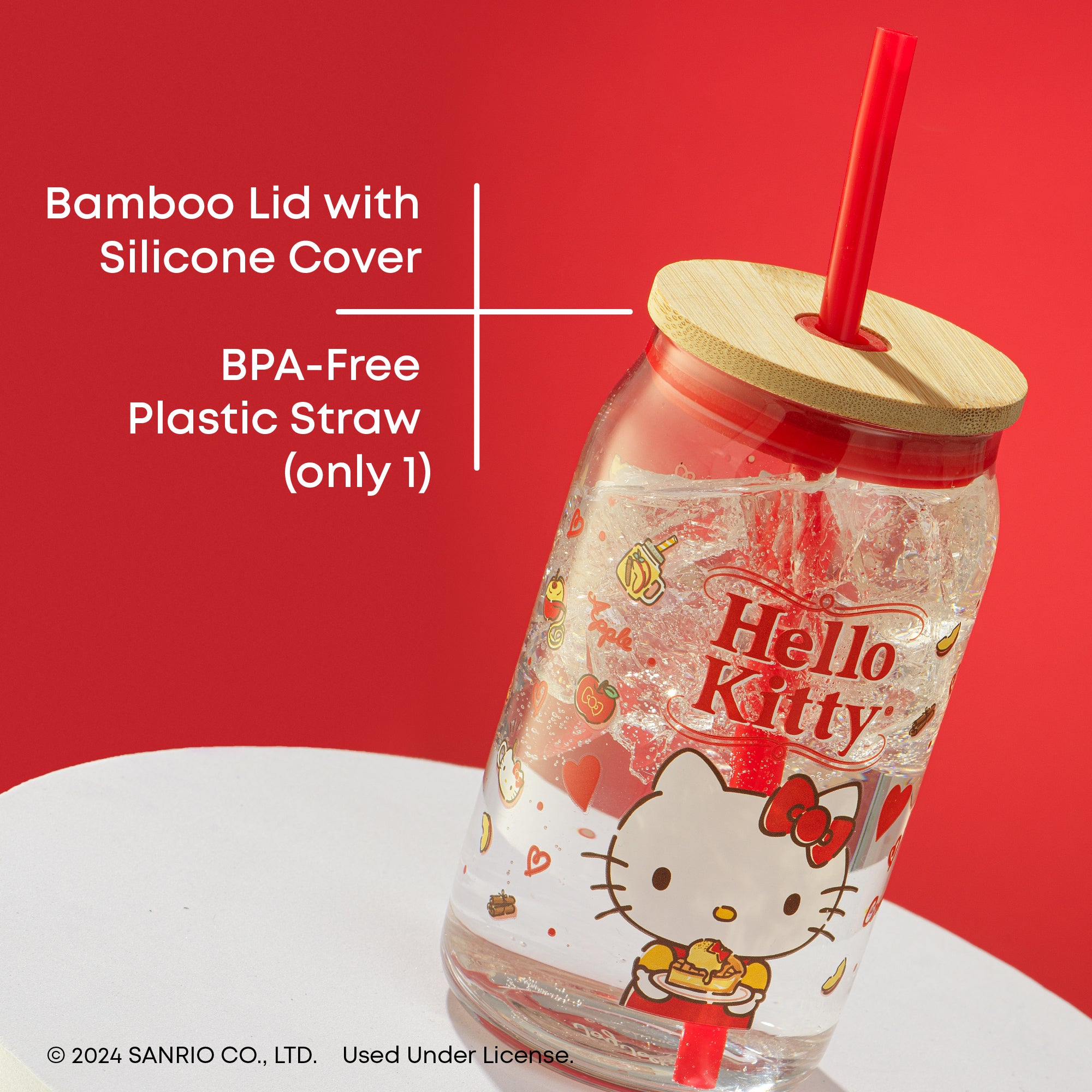 A Hello Kitty glass cup with a bamboo lid and a plastic straw. The cup is transparent and has a red Hello Kitty design. Text on the image reads "Bamboo Lid with Silicone Cover" and "BPA-Free Plastic Straw (only 1)".