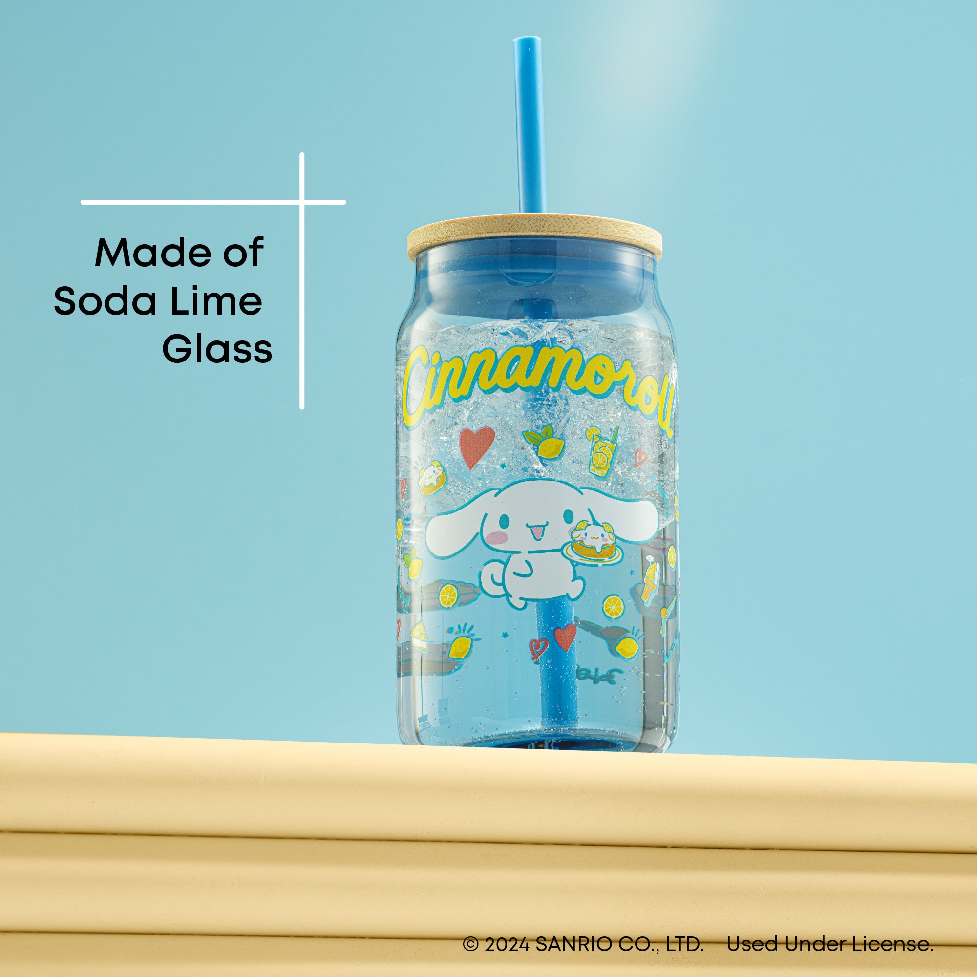 A blue tumbler glass with a bamboo lid and blue straw featuring Cinnamoroll. Text on the image reads, "Made of Soda Lime Glass."