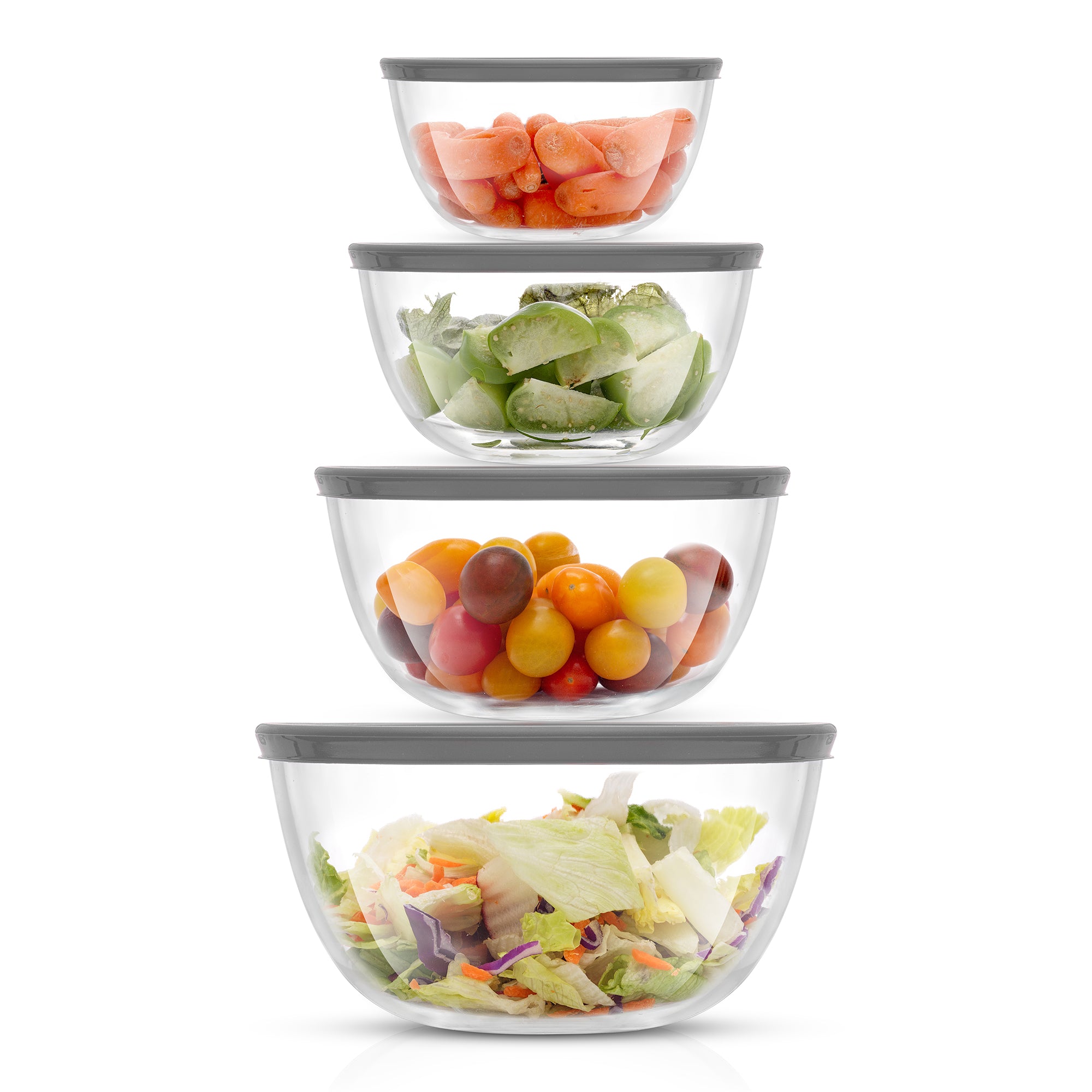  A stack of four glass bowls filled with fruits and vegetables. The bowls sit on a white background.
